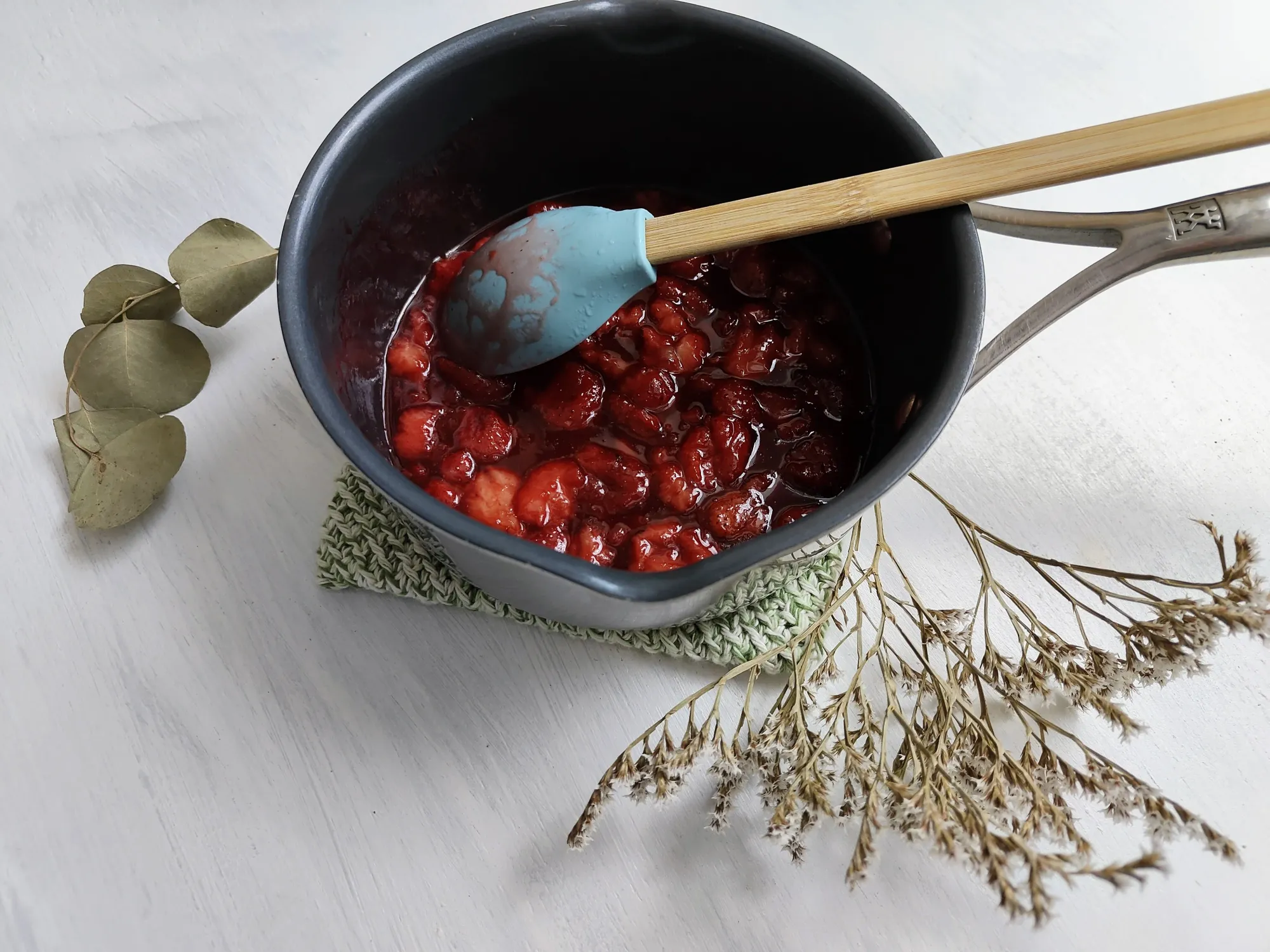 A saucepan of strawberry syrup