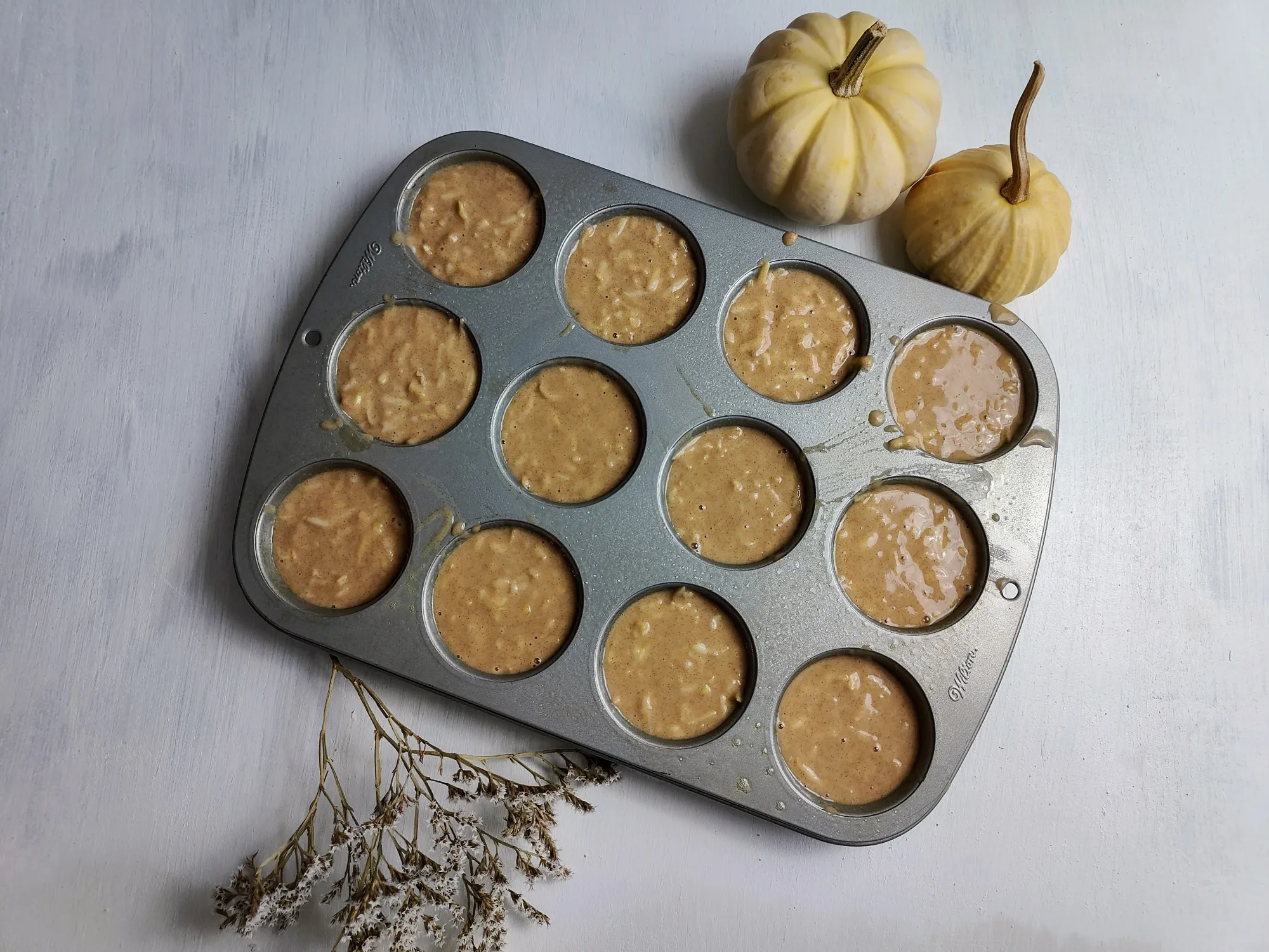 A muffin tin filled with batter