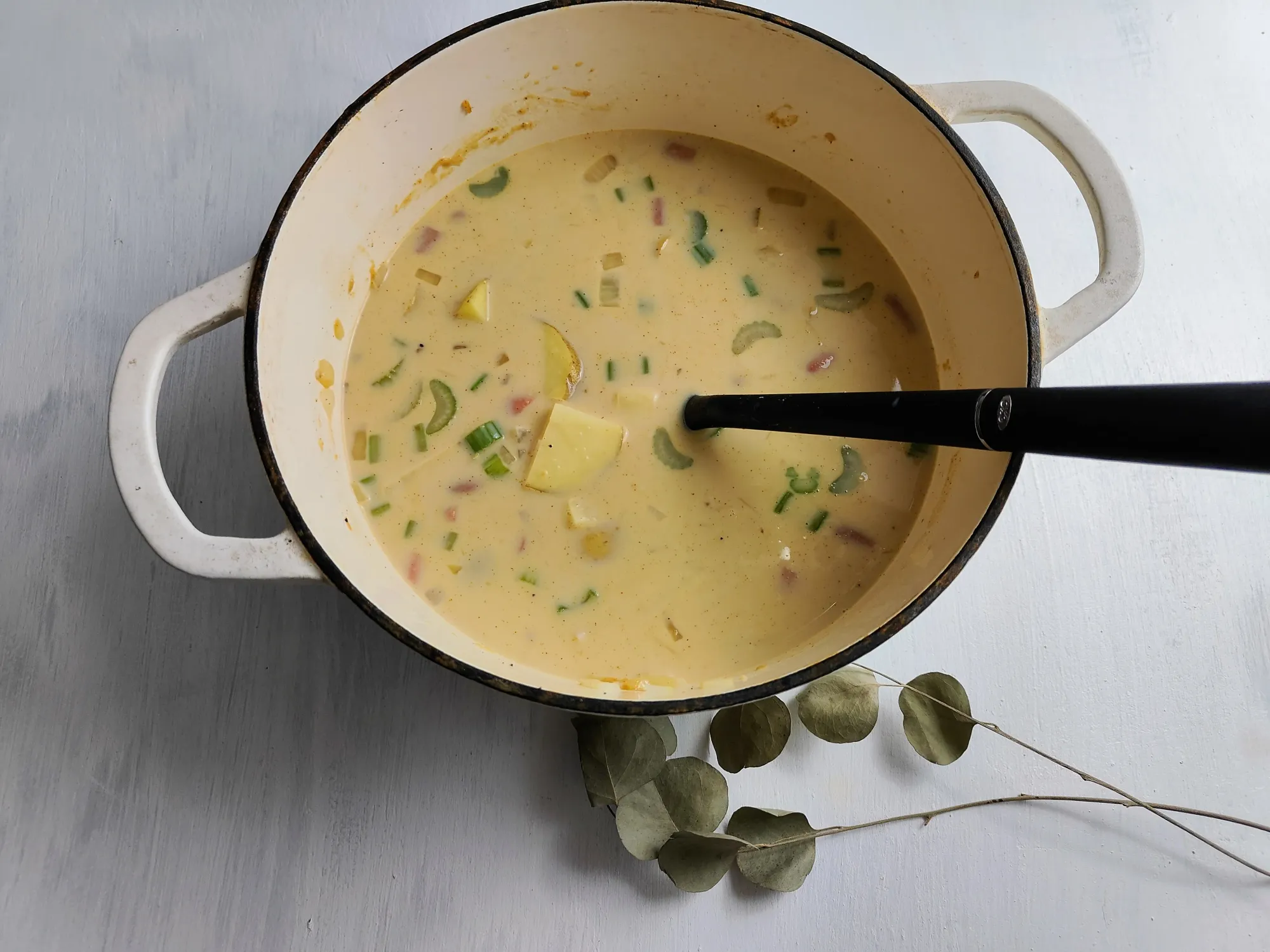 A creamy potato soup in a dutch oven