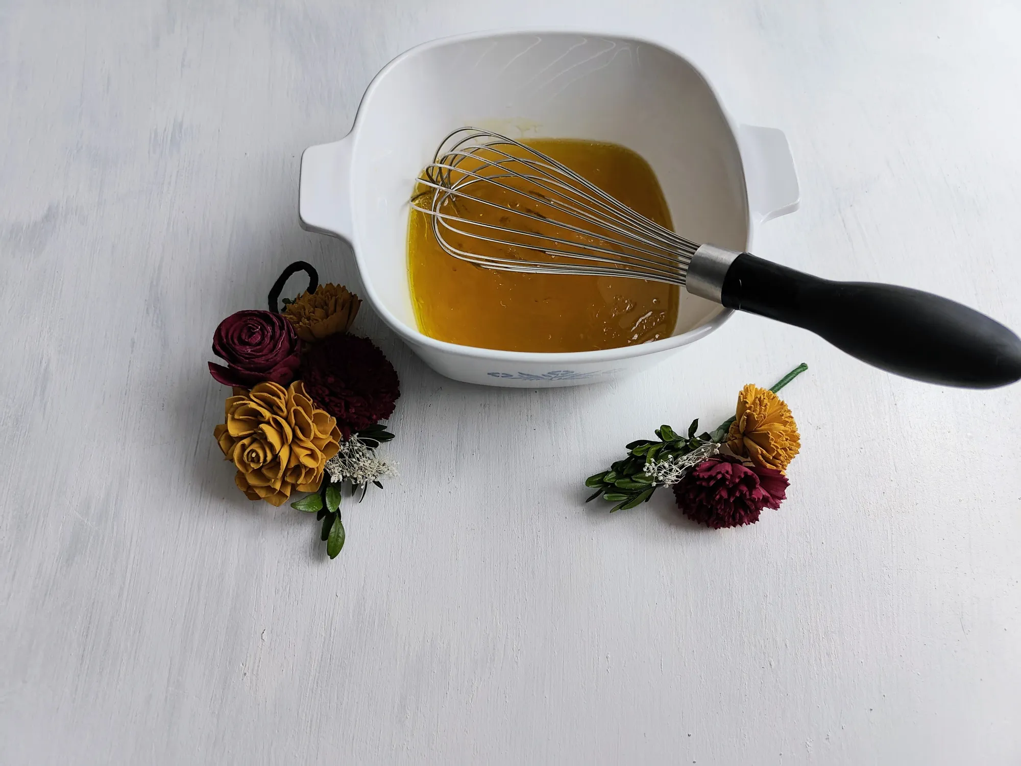 Wet ingredients in a bowl with a whisk