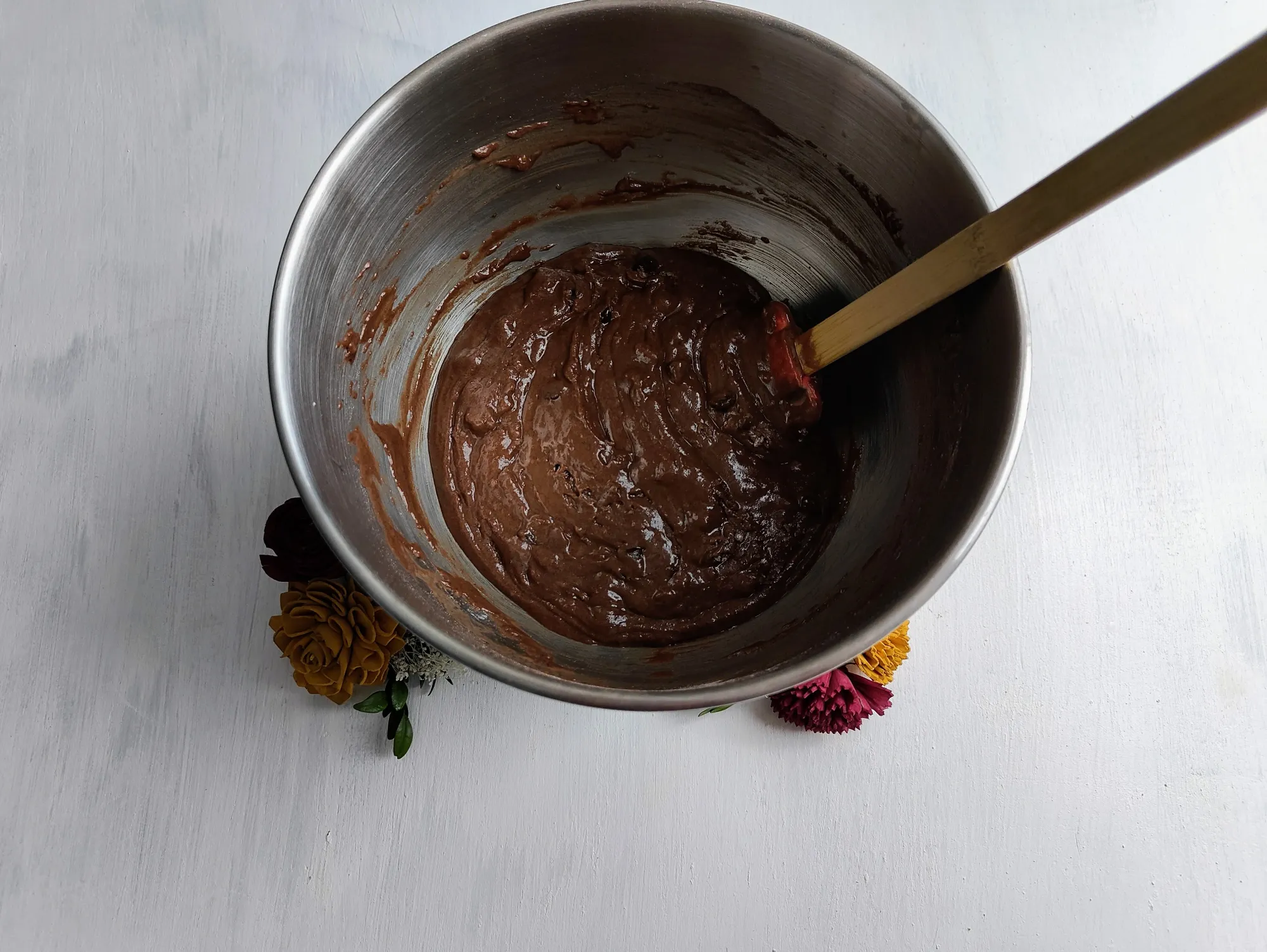 A bowl full of cupcake batter with a spatula