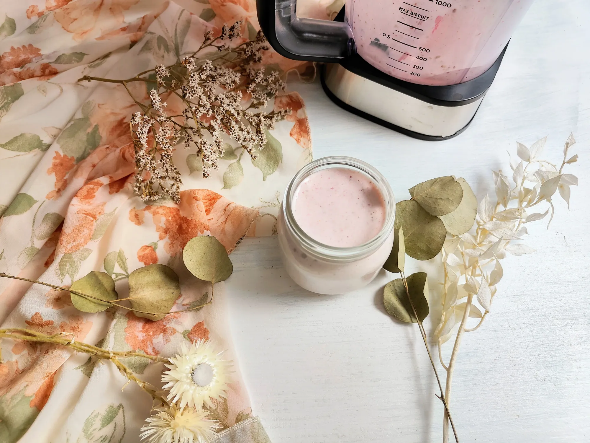 Strawberry overnight oats in a jar next to a blender