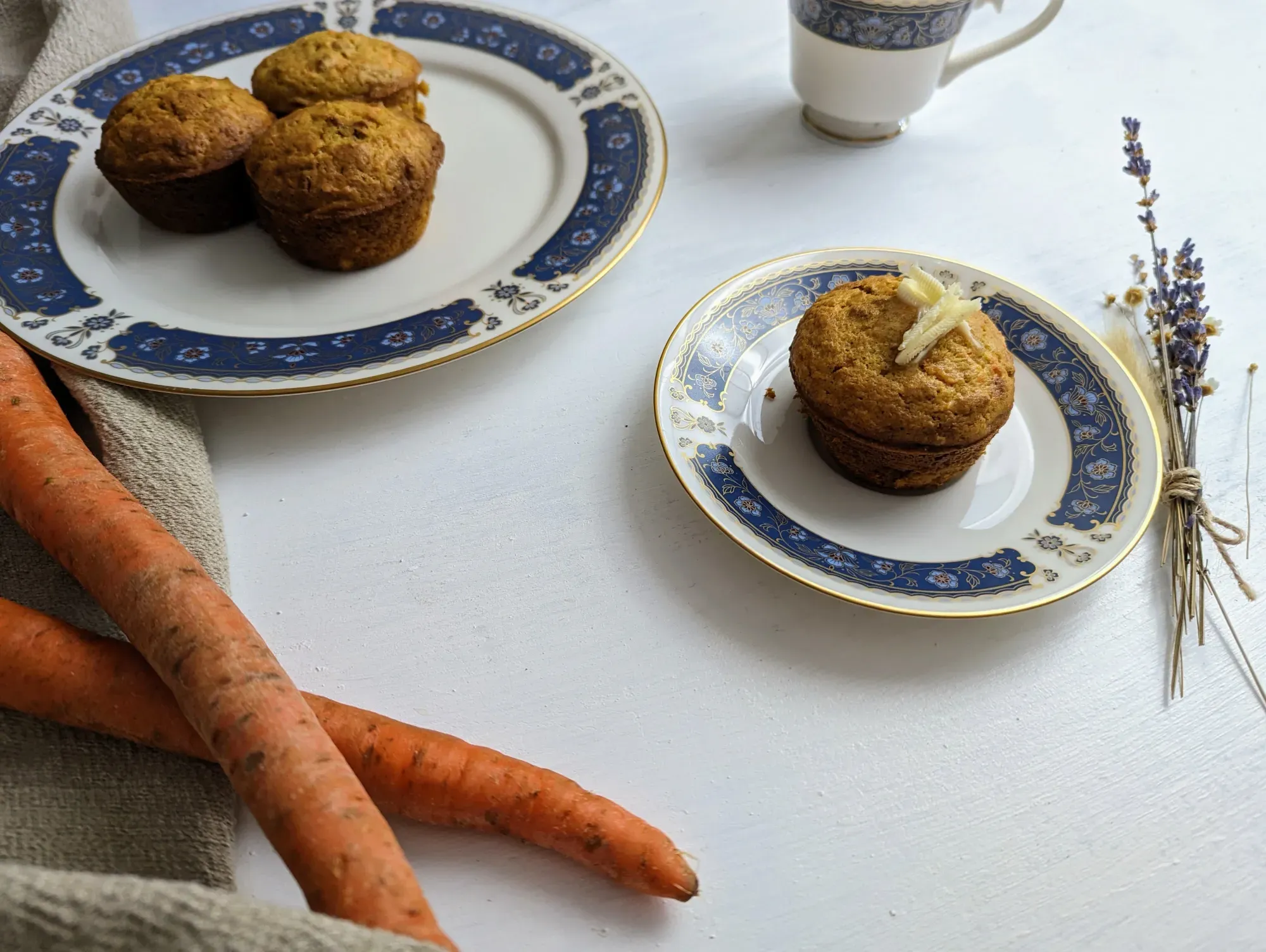 Carrot bran muffin, topped with butter, on a plate